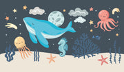 Ocean-themed kids' wall mural with a blue whale, octopus, starfish, and sea creatures in a playful underwater setting.