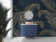 Golden banana leaf wall mural with metallic leaves on a deep black background, styled in a modern bathroom.