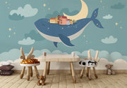 Whale and moon wall mural with a floating village, clouds, and a starry night sky, ideal for kids' rooms and nurseries.