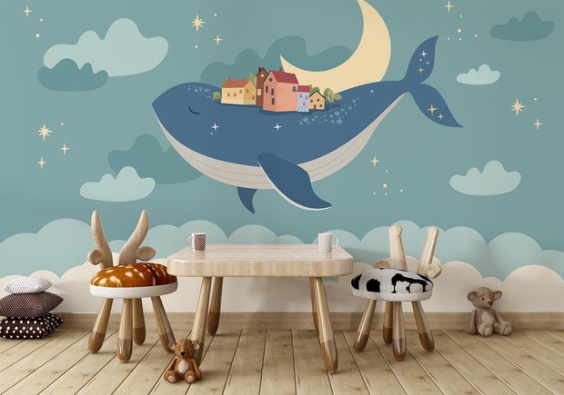 Whale and moon wall mural with a floating village, clouds, and a starry night sky, ideal for kids' rooms and nurseries.