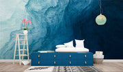 Deep blue abstract wall mural with flowing textures, creating a calming and elegant bedroom atmosphere.