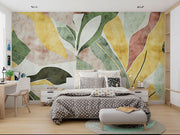 Abstract watercolor leaf wall mural with earthy green, yellow, and terracotta tones in a modern botanical design.