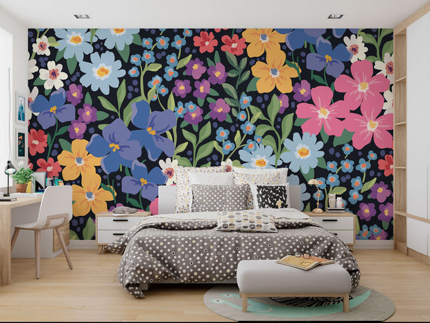 Colorful floral wall mural with hand-painted flowers in shades of blue, pink, yellow, and purple, displayed in a modern bedroom.