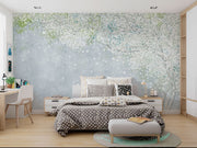 Soft blue and green wall mural with delicate white blossoms, creating a peaceful and elegant ambiance.