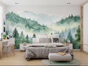 Watercolor forest wall mural with misty mountains and lush green trees, creating a serene and calming nature-inspired ambiance.