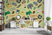 Room interior with a colorful gaming-themed wallpaper featuring game controllers and text.