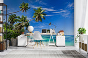 Palm oasis wall mural featuring tall palm trees, white sand, and turquoise waters under a bright blue sky, creating a refreshing workspace atmosphere.