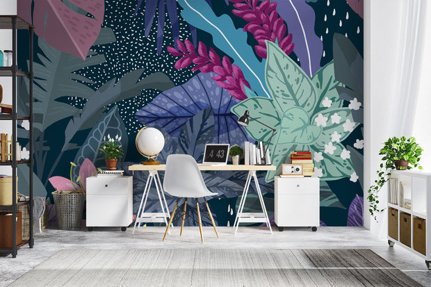 Illustrated tropical botanical wall mural with large jungle leaves, pink lilies, white flowers, and deep blue background, styled in a modern home office.