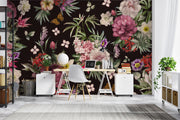 Romantic floral mural behind a modern white desk and tropical houseplants in a home office.