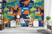 Colorful dinosaur themed wall mural featuring vibrant dinosaur silhouettes, footprints and phrases like "ROAR" and "DANGER," decorating a kid's room with cozy furniture.