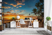 Golden sunset wall mural with palm trees, vibrant sky, and tranquil ocean waves, creating a relaxing and coastal living room ambiance.