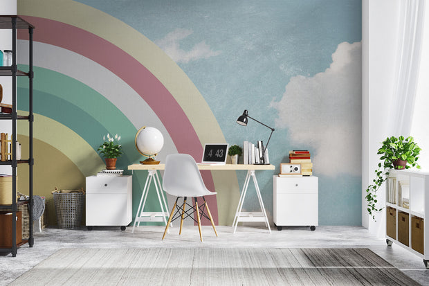 Modern workspace with retro pastel rainbow wall mural and sky backdrop, styled with minimalist white furniture and indoor plants.
