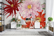 Oversized floral wall mural featuring red, pink, and yellow illustrated blooms with green leaves decorating a modern home office.