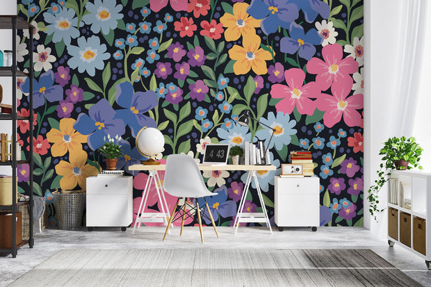 Colorful floral wall mural with hand-painted flowers in shades of blue, pink, yellow, and purple, displayed in a modern home office.