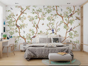 Nature-inspired floral and bird wall mural featuring blooming flowers, branches, birds, and butterflies in a living room setting.