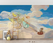 A children's room with a whimsical wall mural showcasing butterflies carrying woodland animals across a cloud-filled sky. The room features soft furnishings, wooden toys, and cozy decor elements.