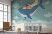 Whale and moon wall mural with a floating village, clouds, and a starry night sky, ideal for kids' rooms and nurseries.