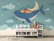 Whale and moon wall mural with a floating village, clouds, and a starry night sky, ideal for kids' rooms and nurseries.