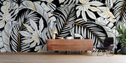 Black and white tropical leaf wall mural with gold accents, featuring monstera and palm leaves in a modern botanical design.