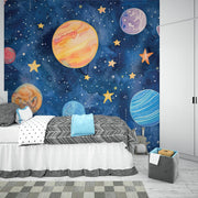 Hand-painted watercolor-style wall mural of planets, stars, and a dreamy blue galaxy, ideal for decorating kids’ bedrooms or playrooms.