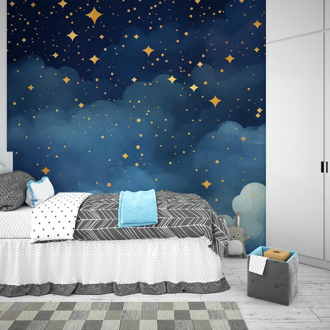 Starry night wall mural with golden stars and deep blue watercolor-style clouds, decorating a cozy bedroom with patterned bedding, soft toys and storage.