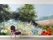 Hand-painted wall mural featuring a summer meadow with wildflowers, daisies, tall grass, and a soft blue sky, creating a peaceful countryside scene.
