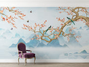 Chinoiserie-style wall mural featuring cherry blossom branches, perched birds, and misty blue mountains, creating a serene and elegant atmosphere.
