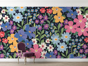 Colorful floral wall mural with hand-painted flowers in shades of blue, pink, yellow, and purple, displayed in a living room with a chair.