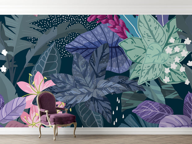 Illustrated tropical botanical wall mural with large jungle leaves, pink lilies, white flowers, and deep blue background, styled in a modern living room.