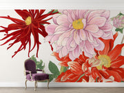 Oversized floral wall mural featuring red, pink, and yellow illustrated blooms with green leaves behind a burgundy chair.