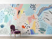 Playful abstract wall mural with colorful brushstrokes, dotted patterns, and modern art elements in a living room setting.