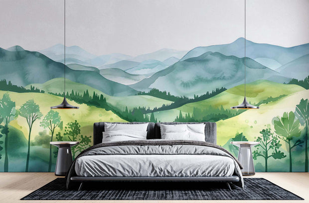 Watercolor green hills wall mural featuring lush rolling landscapes and soft blue mountains, styled in a cozy modern bedroom.