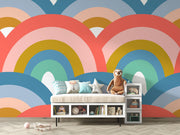 Colorful retro rainbow mural in a kids playroom, pastel toys, and playful decor.