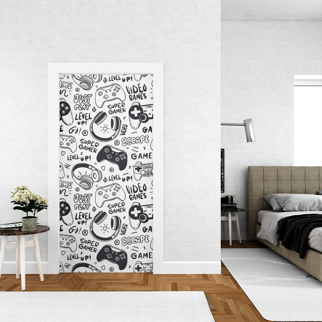 Black-and-white gaming-themed door mural featuring video game controllers, gamer doodles, and phrases like "Level Up!" and "Just Play!"