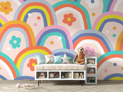 Kids wall mural with retro-style rainbow arches and colorful flowers in a playful, vintage-inspired nursery.