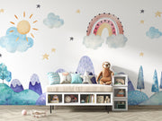 Watercolor kids' room mural with pastel mountains, a rainbow, a sun, clouds, and stars for a dreamy, playful atmosphere.