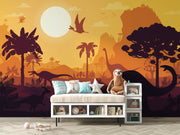 Kids’ dinosaur wall mural featuring silhouettes of Brachiosaurus, Pterosaurs, and prehistoric trees against an orange sunset, ideal for a playful bedroom or playroom.