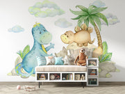 Cute dinosaur wall mural with watercolor-style dinosaurs, tropical plants, and soft pastel clouds, perfect for nurseries, kids' bedrooms, and playrooms.