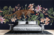 Exotic Leopard Wall Mural featuring a detailed leopard walking through lush tropical flowers and leaves on a dark background.