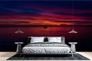 Sunset Over the Ocean Wall Mural – Stunning Seascape Wallpaper Featuring a Sailboat Silhouette, Deep Twilight Sky, and Serene Ocean Waters for Relaxing Interiors.