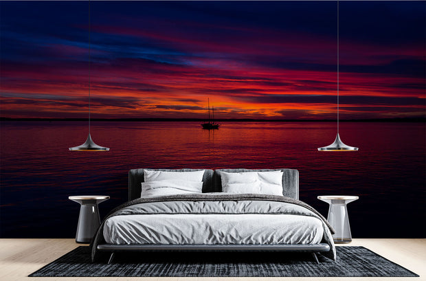 Sunset Over the Ocean Wall Mural – Stunning Seascape Wallpaper Featuring a Sailboat Silhouette, Deep Twilight Sky, and Serene Ocean Waters for Relaxing Interiors.