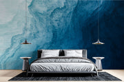 Deep blue abstract wall mural with flowing textures, creating a calming and elegant bedroom atmosphere.