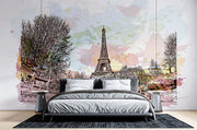 Watercolor Paris mural featuring the Eiffel Tower with pastel skies and ink sketch trees in a stylish bedroom setting.