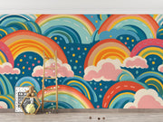 Bold and colorful rainbow wall mural with pink clouds and blue background, decorating kids playroom.