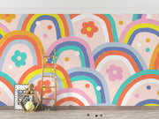 Kids wall mural with retro-style rainbow arches and colorful flowers in a playful, children's playroom.
