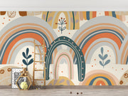 Boho-style kids wall mural with hand-drawn earthy rainbows, abstract florals, and neutral tones in a modern children's playroom.