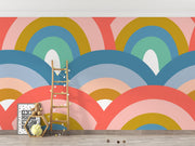 Colorful retro rainbow mural in a kids playroom.