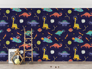 Space Dinosaurs Wall Mural featuring colorful astronaut dinosaurs, planets and stars; decorating kid's bedroom.