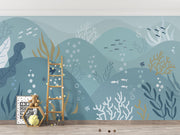 Underwater-themed ocean wall mural featuring fish, seaweed, bubbles, and rolling waves in soft blues and greens. Ideal for kids’ rooms and ocean-inspired interiors.