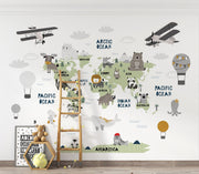 Scandinavian style children's world map wall mural with cute animals and airplanes, styled in a kid's playroom.